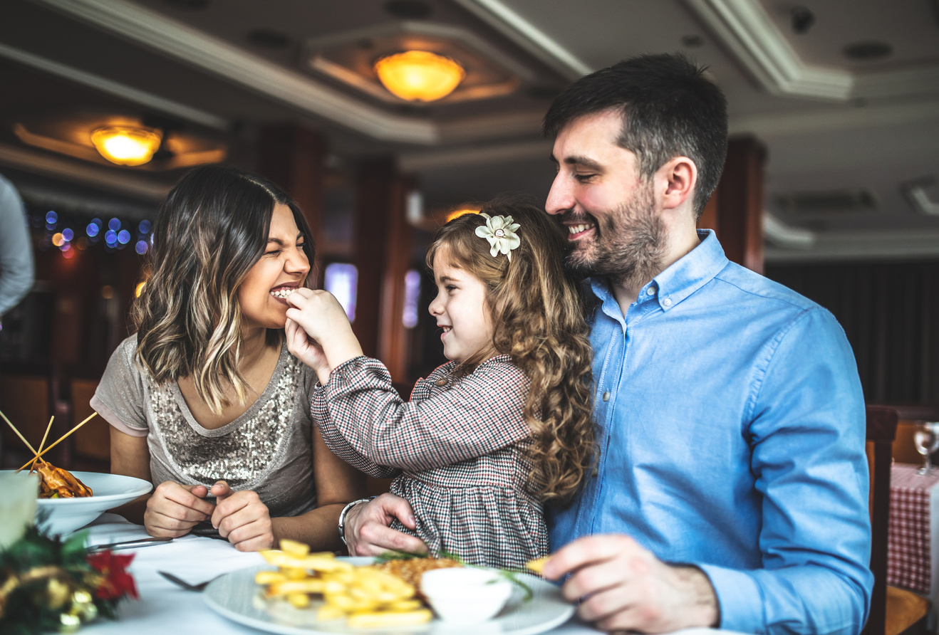 Portrait of happy family eating in the restaurant